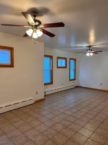 a view of a livingroom with a ceiling fan and window