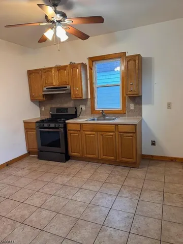 a kitchen with stainless steel appliances cabinets a sink and a stove
