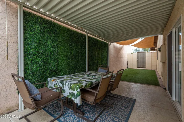 a backyard of a house with table and chairs