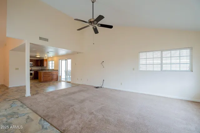 an empty room with a empty space and windows