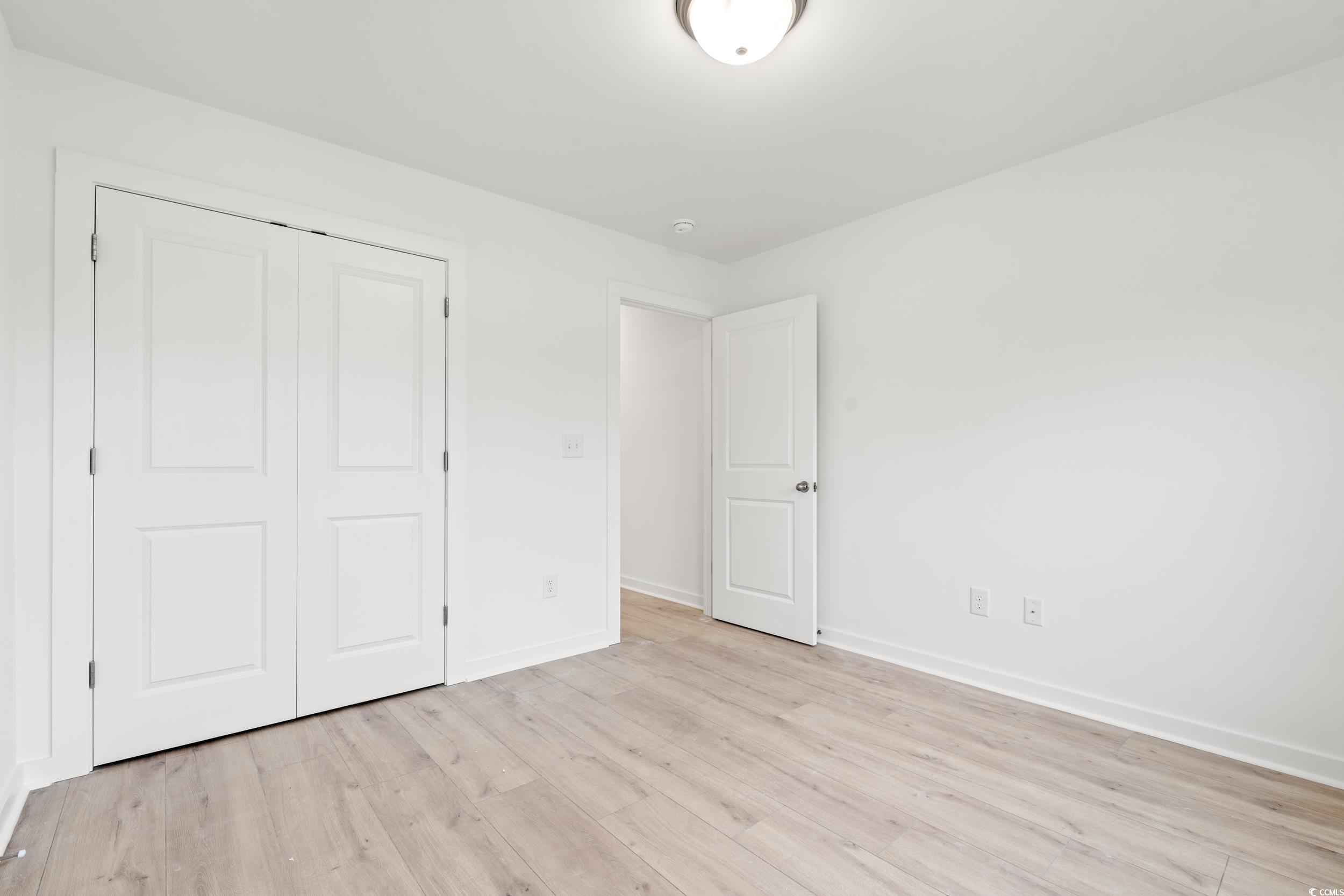 2827 Biscane Court Conway, SC 29527 - Photo 20 of 31 Unfurnished bedroom with light wood-style floors and a closet