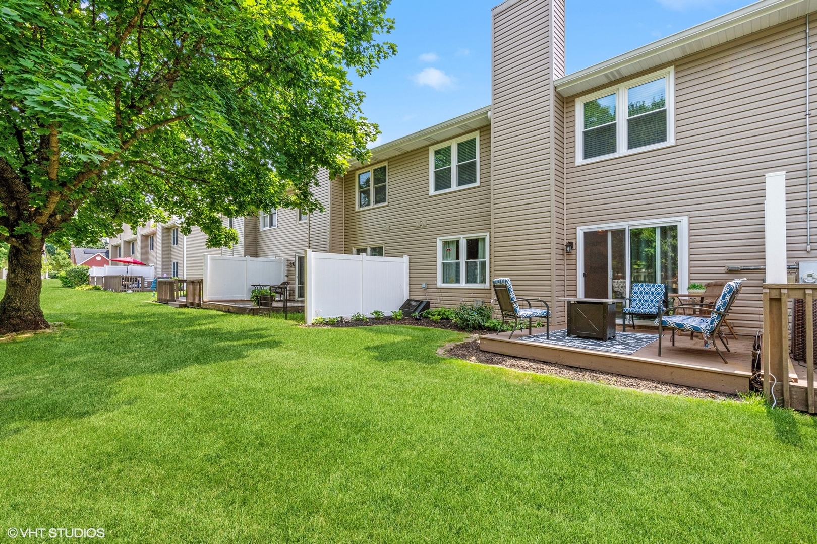 513 Hunters Way Fox River Grove, IL 60021 - Photo 16 of 16 a view of a backyard with table and chairs potted plants and a large tree