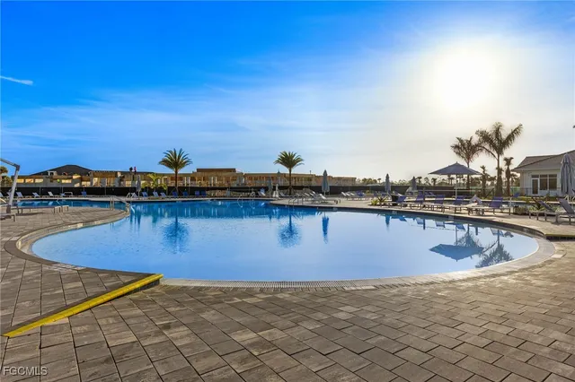 a view of swimming pool with outdoor seating