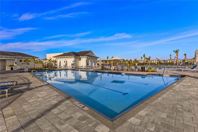 a view of a swimming pool with an outdoor seating