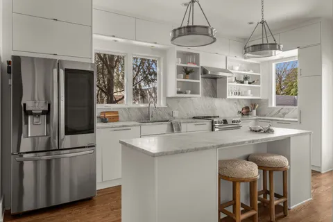 a kitchen with granite countertop a stove and cabinets