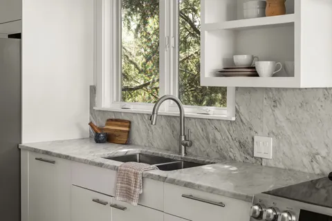 a kitchen with a sink stove and cabinets