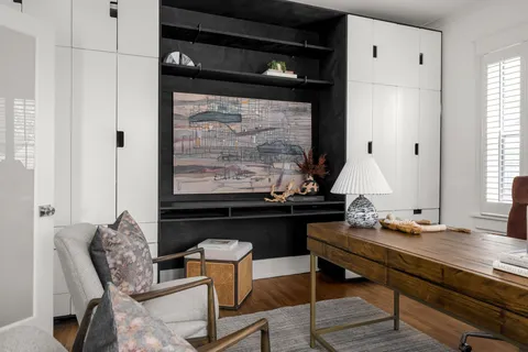 a living room with furniture potted plant and a fireplace