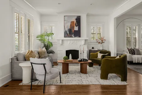 a living room with furniture and a chandelier