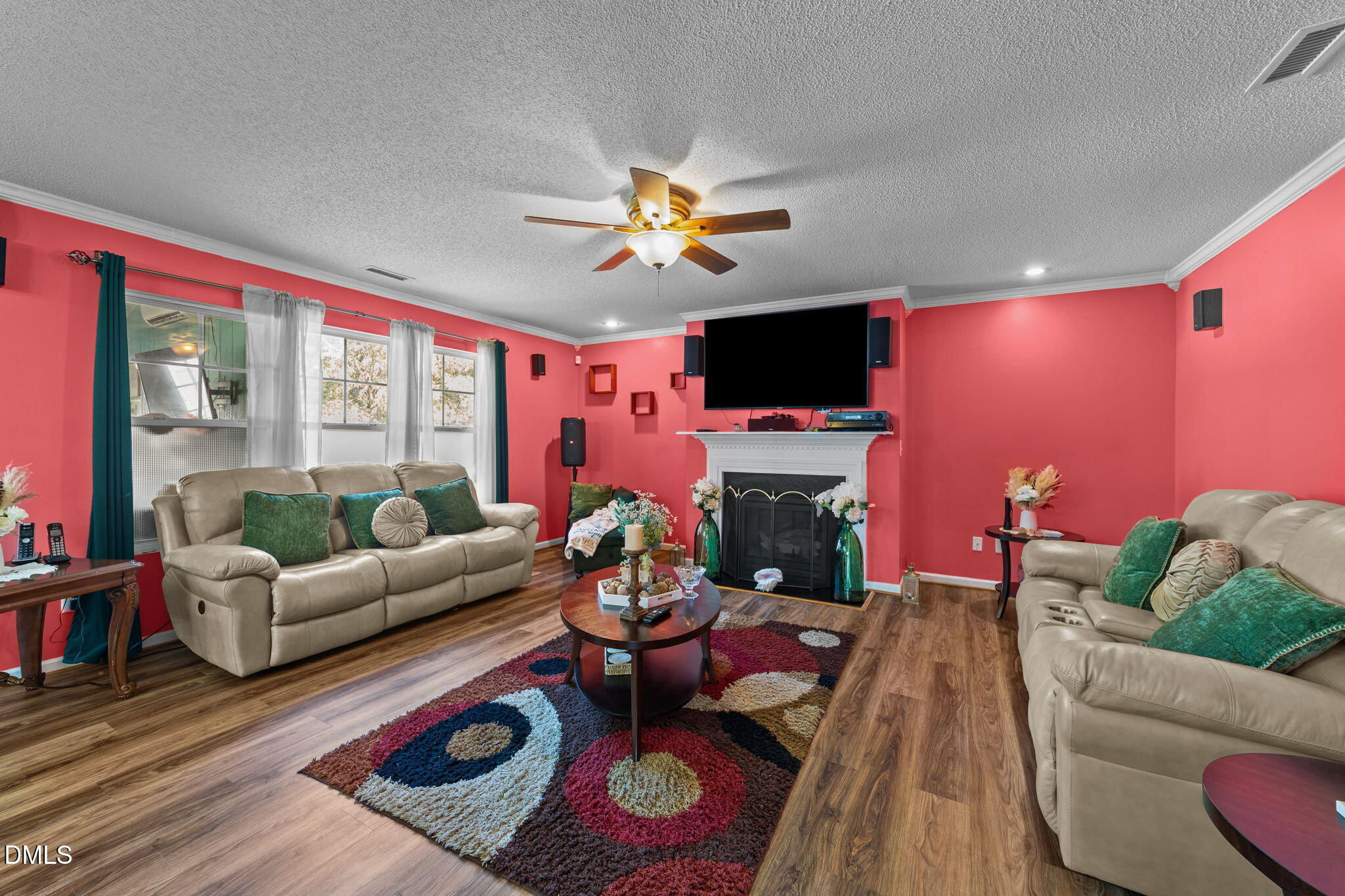 135 Oakton Ridge Place Garner, NC 27529 - Photo 13 of 40 a living room with furniture a fireplace and a flat screen tv