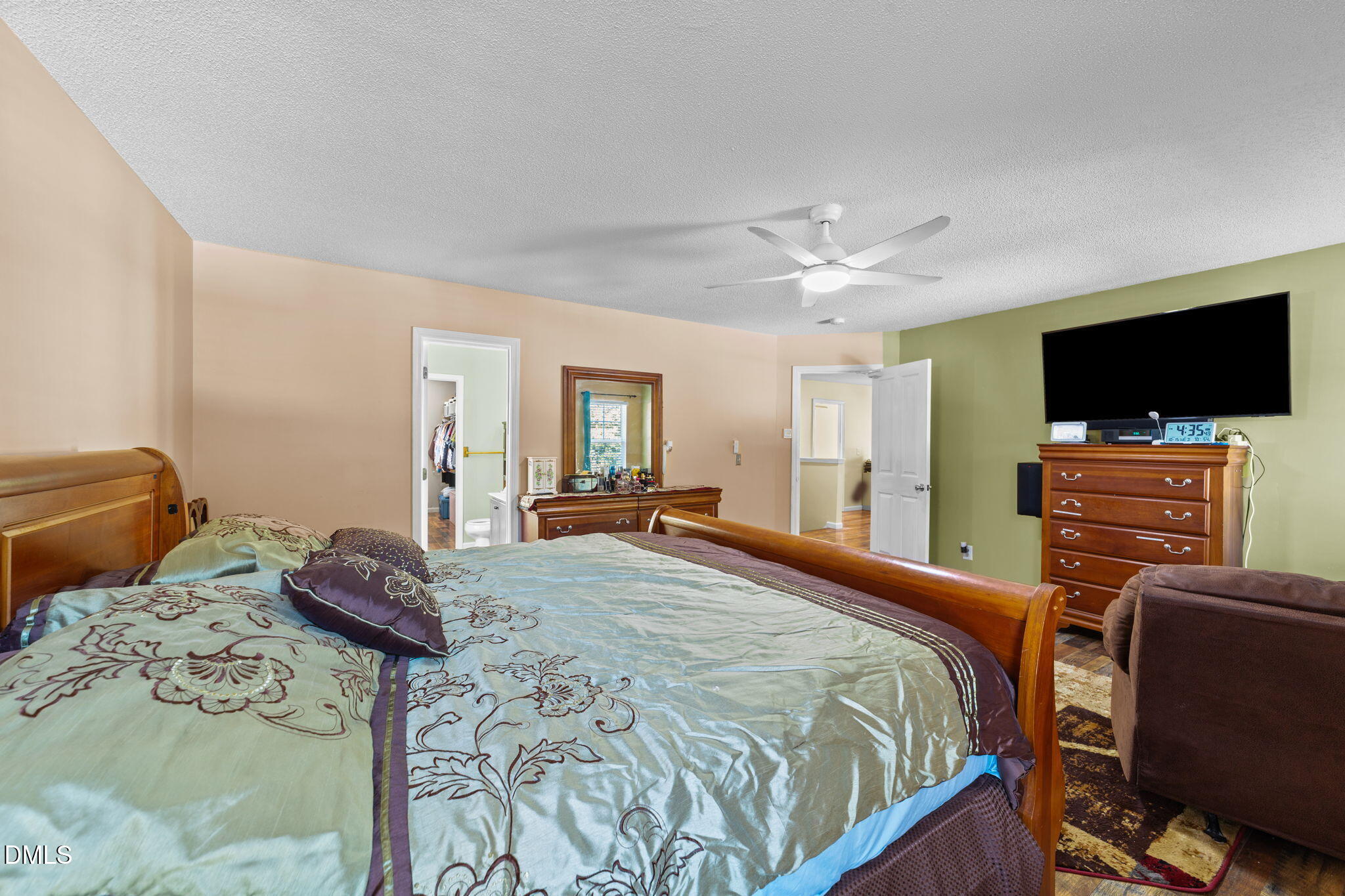 135 Oakton Ridge Place Garner, NC 27529 - Photo 26 of 40 a bedroom with a bed and a flat screen tv