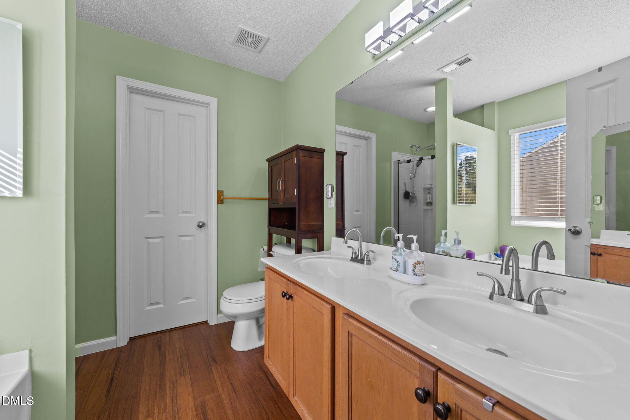 135 Oakton Ridge Place Garner, NC 27529 - Photo 28 of 40 a bathroom with a double vanity sink mirror and toilet