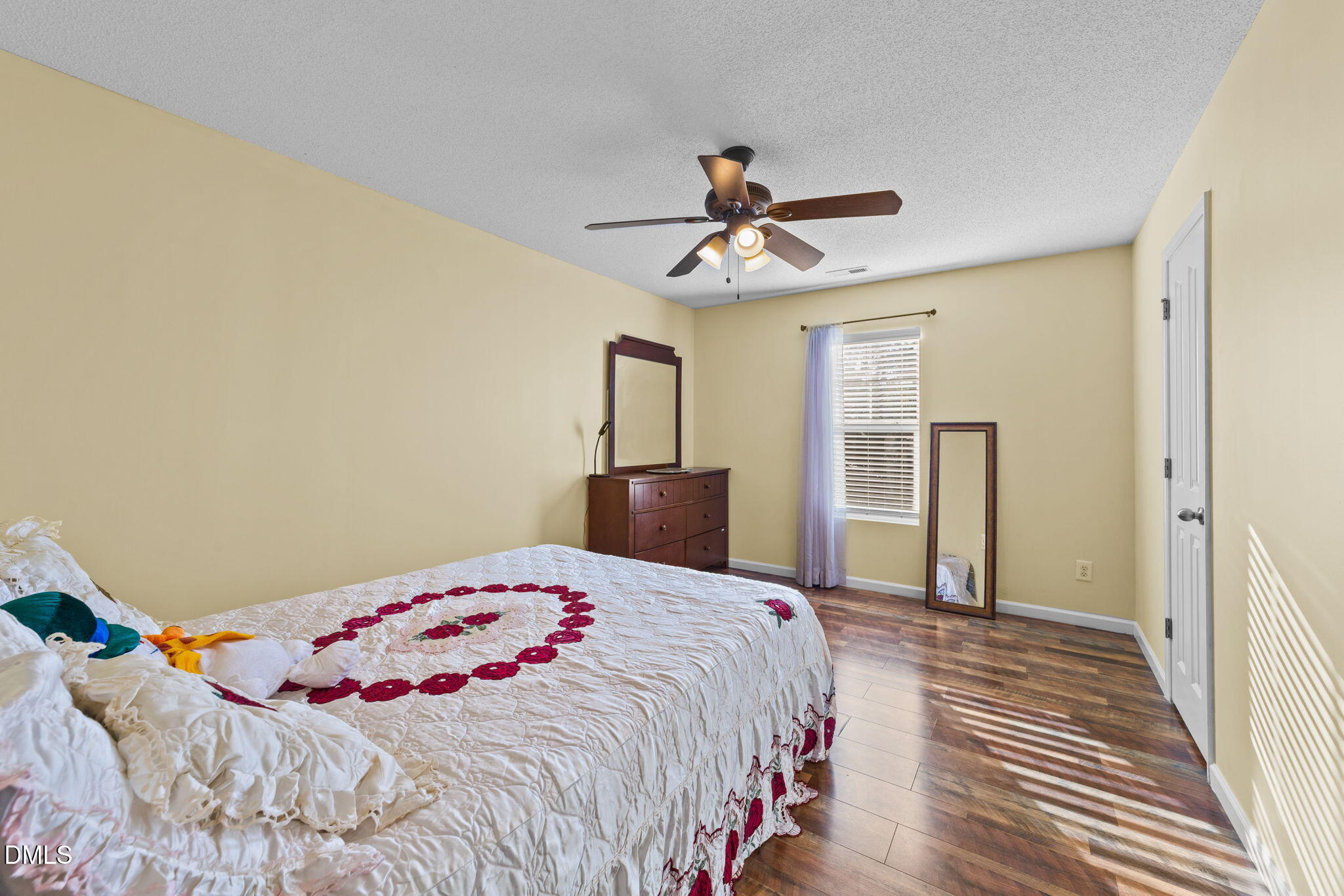 135 Oakton Ridge Place Garner, NC 27529 - Photo 31 of 40 a bedroom with a bed and a chandelier