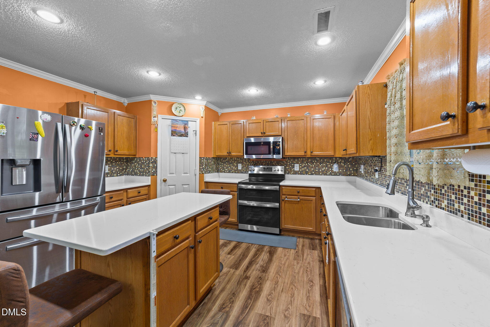 135 Oakton Ridge Place Garner, NC 27529 - Photo 9 of 40 a kitchen with a sink stove and refrigerator