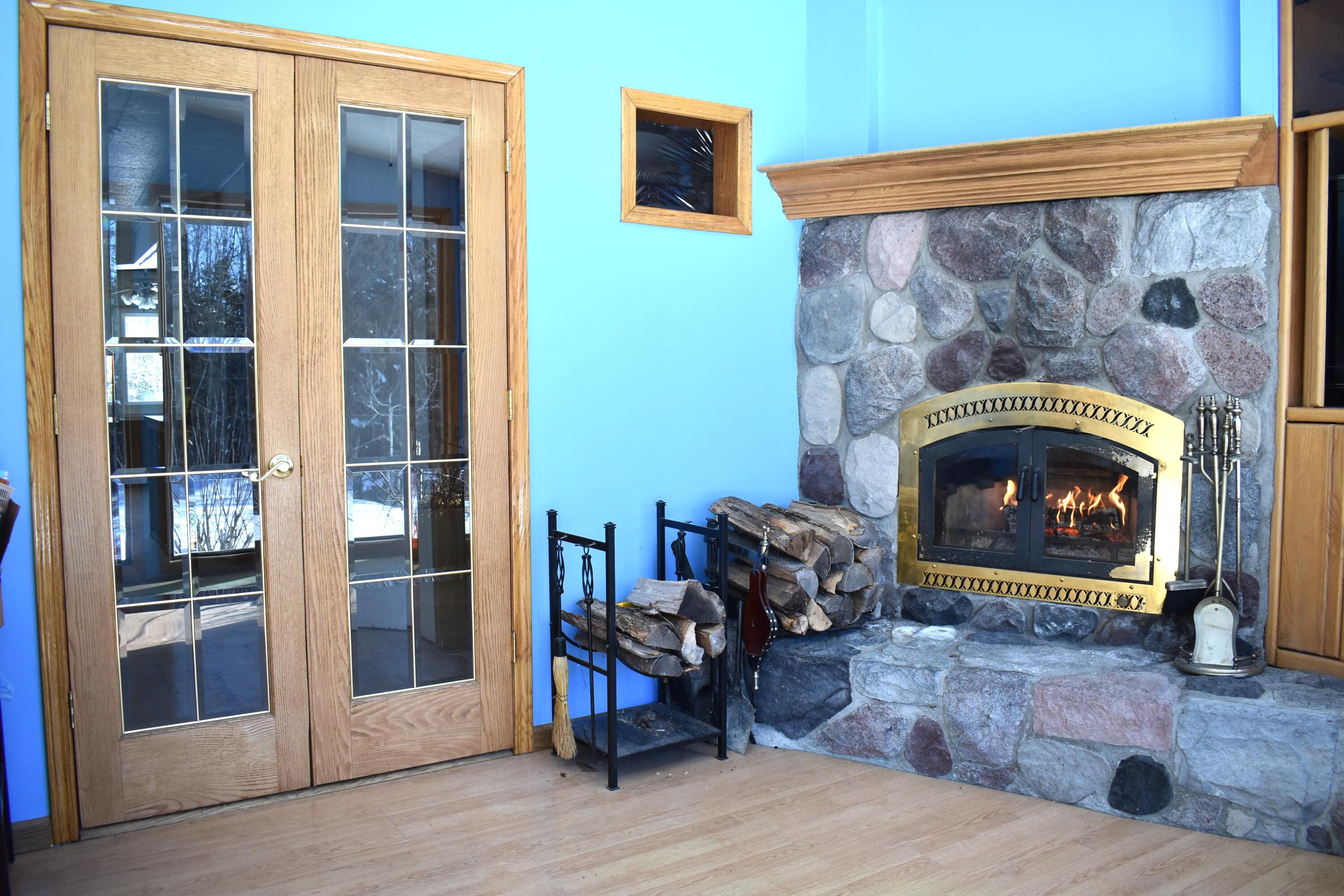 2939 Grant Siding Road Cheboygan, MI 49721 - Photo 25 of 54 Sunroom Fireplace