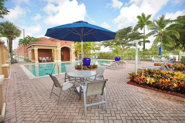 a view of a chairs and table in the patio with a fire pit