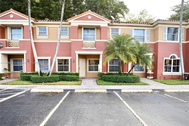 front view of a brick house with a yard