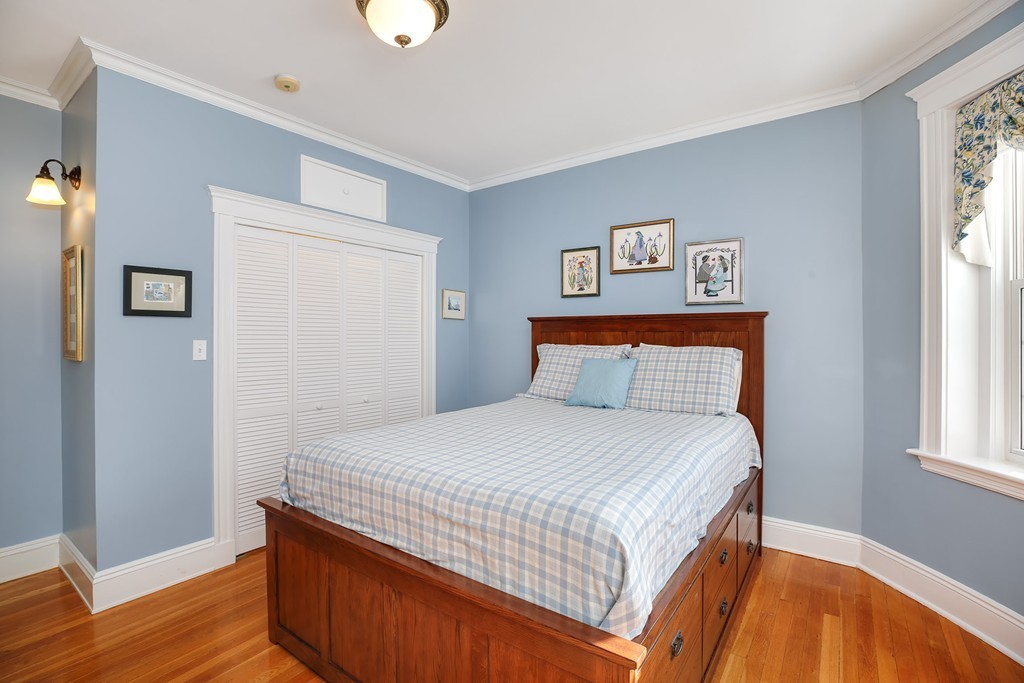 94 University Road, Unit 3 Brookline, MA 02446 - Photo 12 of 20 a bedroom with a bed and wooden floor