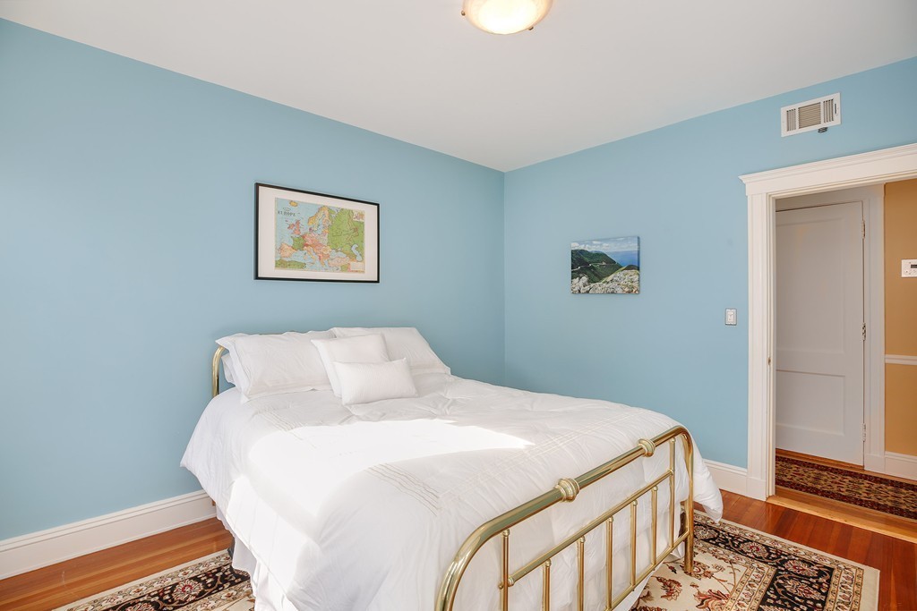 94 University Road, Unit 3 Brookline, MA 02446 - Photo 14 of 20 a bedroom with a bed and a painting on the wall