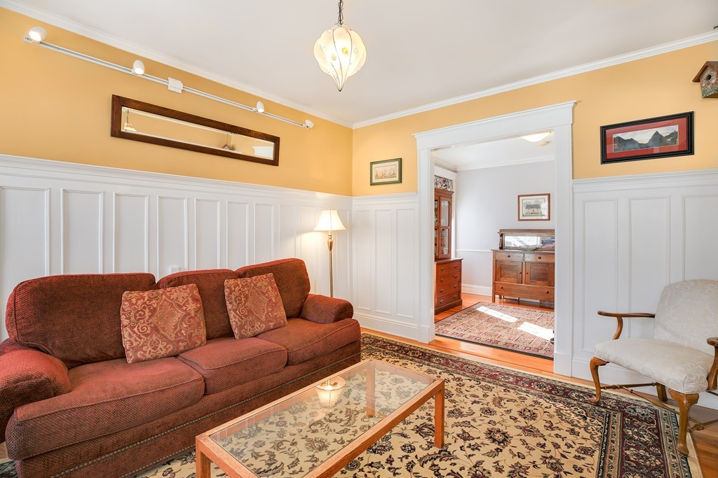 94 University Road, Unit 3 Brookline, MA 02446 - Photo 3 of 20 a blue couch sitting in a living room with a couch