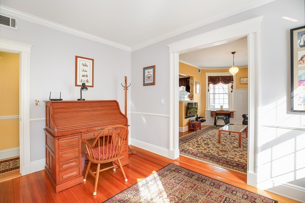 94 University Road, Unit 3 Brookline, MA 02446 - Photo 10 of 20 a living room with a dining table and chairs