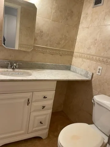 a bathroom with a sink a toilet and mirror