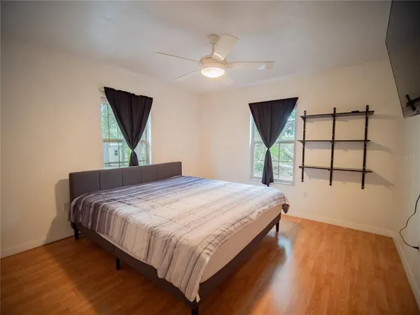 a bedroom with a bed and a large window