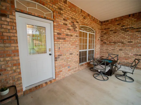 an aerial view of a house with plants and large trees
