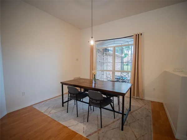 a view of a room that has a table and chairs in it
