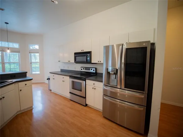a kitchen with a refrigerator and a sink