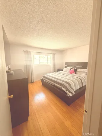 a bedroom with a bed and a night stand
