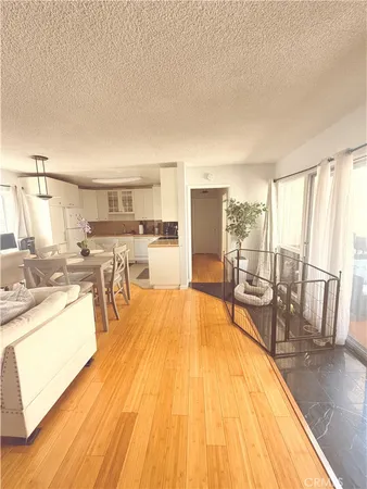 a dining room with furniture a chandelier and wooden floor