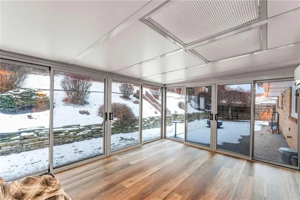 a view of a room with window and wooden floor