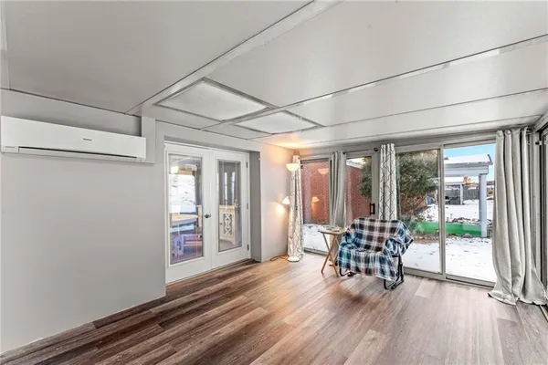 a room with wooden floor and furniture