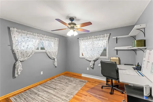 a workspace with furniture window and wooden floor