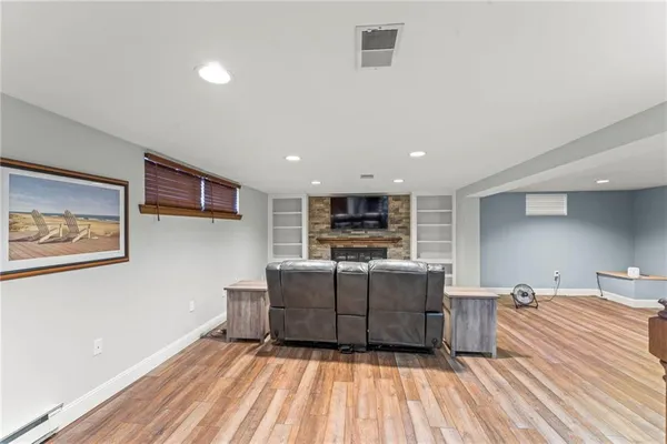 a living room with furniture and a wooden floor
