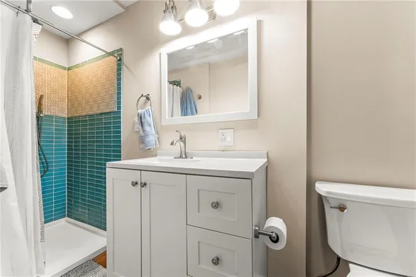 a bathroom with a sink a toilet and mirror