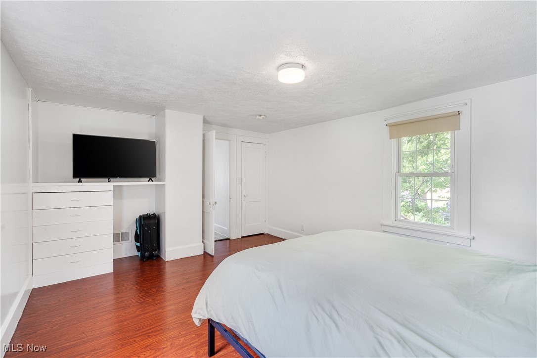 929 Johnson Plank Road Warren, OH 44481 - Photo 14 of 21 Bedroom with wood finished floors and a textured ceiling