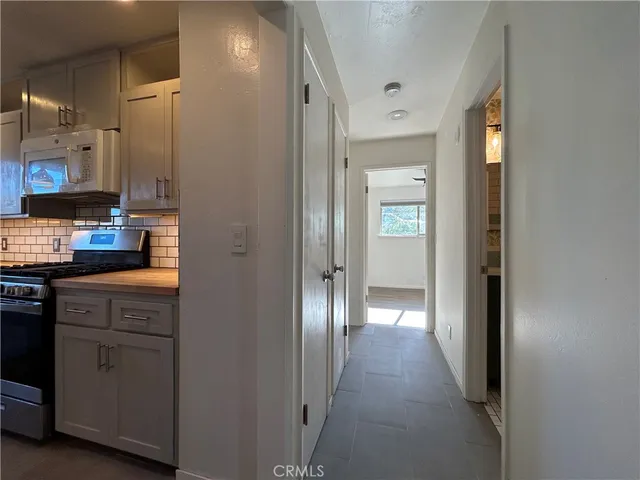 a view of backyard with outdoor seating space and trees
