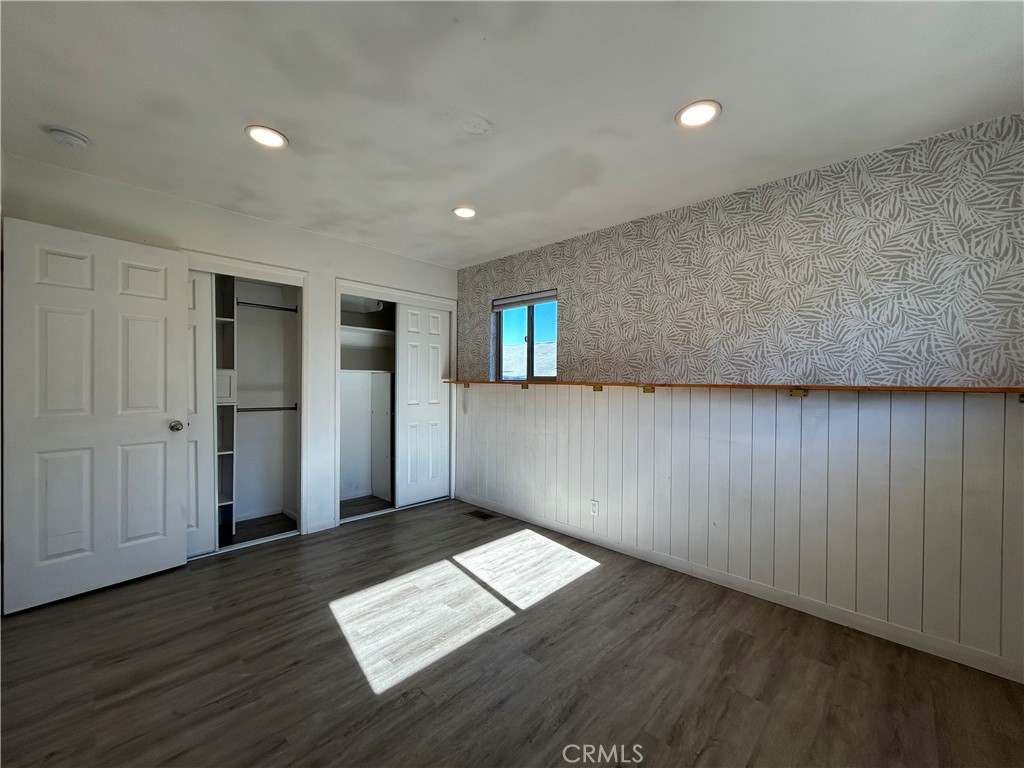 941 Marina Street Morro Bay, CA 93442 - Photo 21 of 36 an empty room with wooden floor and windows