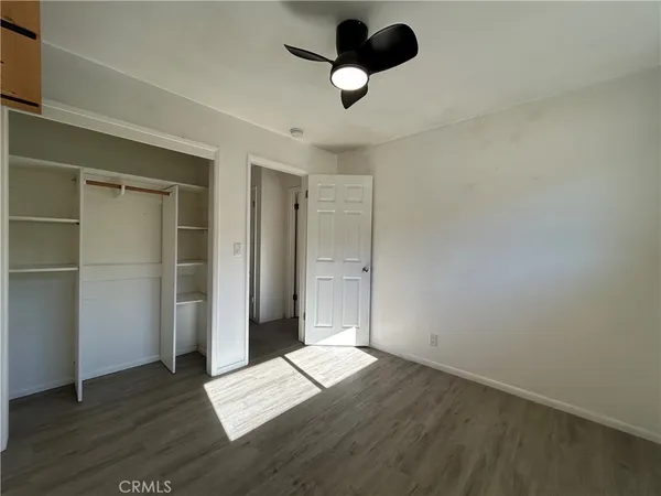 a view of an empty room and wooden floor