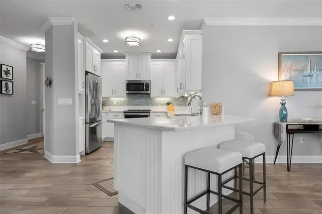 a kitchen with a sink cabinets and refrigerator