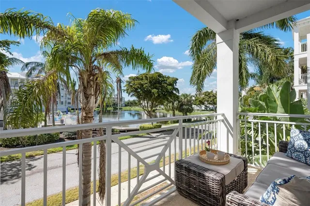 a view of a balcony with lake view and a potted plant