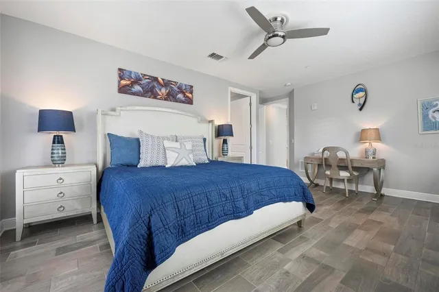 a bedroom with a bed and a chandelier