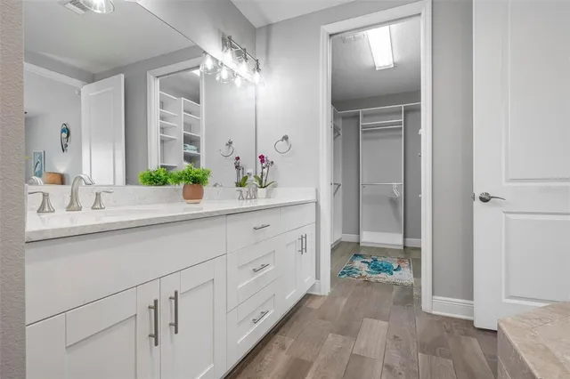 a spacious bathroom with a double vanity sink and a mirror