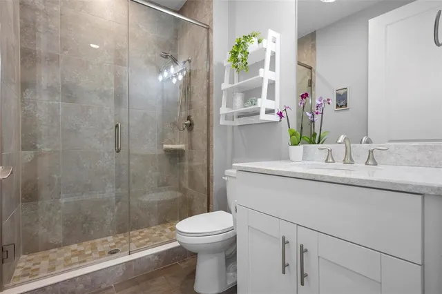 a bathroom with a sink toilet and shower