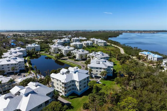 an aerial view of a houses with a lake