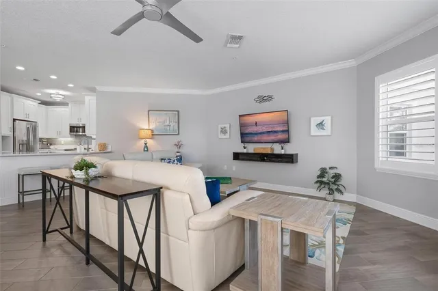 a living room with furniture a two couches and a flat screen tv