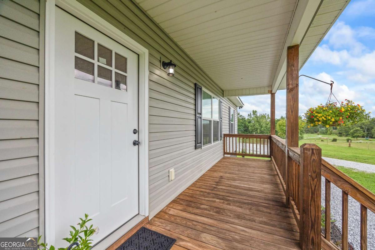 1718 Ed Bennett Road Nicholson, GA 30565 - Photo 16 of 71 a view of a balcony with wooden floor