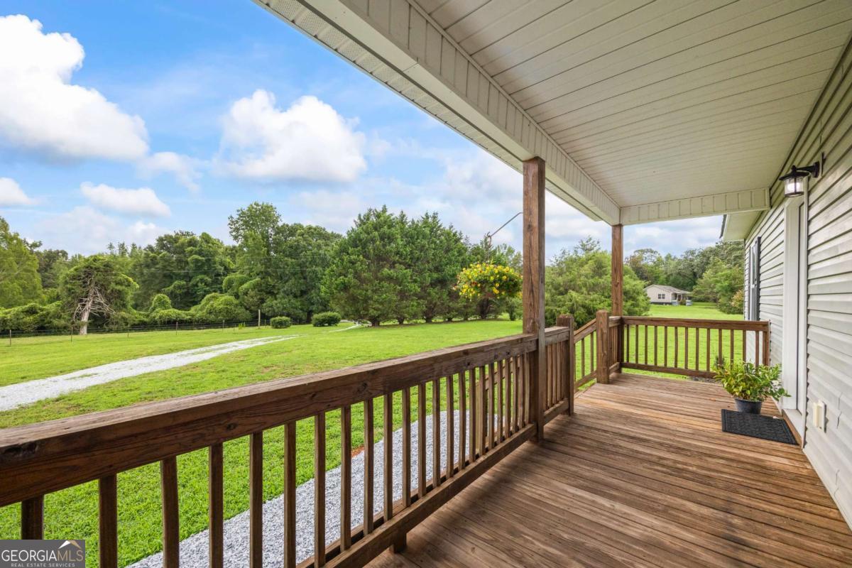 1718 Ed Bennett Road Nicholson, GA 30565 - Photo 16 of 70 a view of a porch with wooden floor of a house