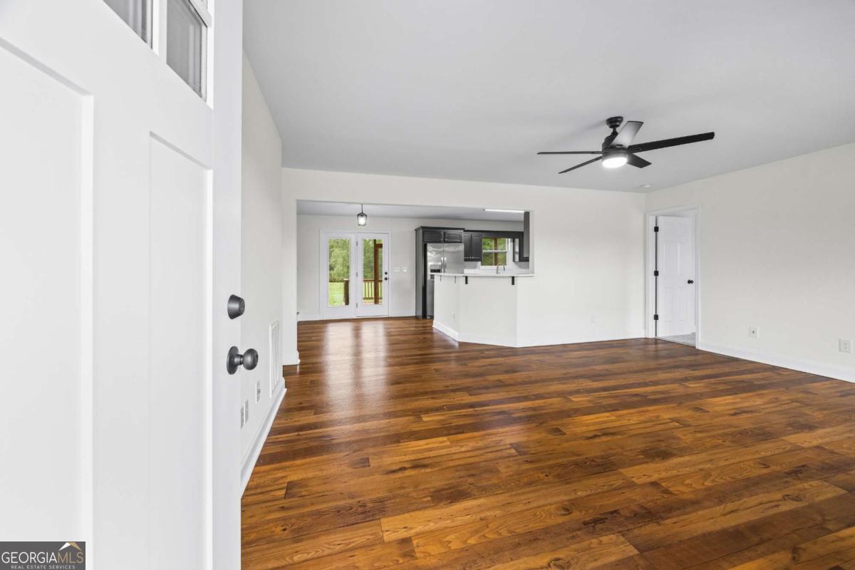 1718 Ed Bennett Road Nicholson, GA 30565 - Photo 18 of 71 a view of a room with wooden floor and ceiling fan